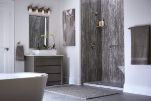 A remodeled bathroom. There's a white tub at the left of the image and a gray walk-in shower on the right.