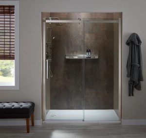 Picture of a shower that was recently converted from a bathtub in a gray bathroom.
