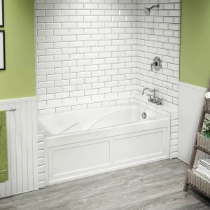 Picture of a stylish bathroom with green walls and a white bathtub.