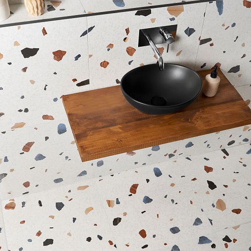 A terrazzo vanity countertop with a bowl sink basin. 