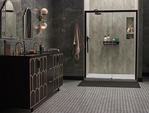 A bathroom with marbled walls, a brown his-and-her vanity and a walk-in shower. 