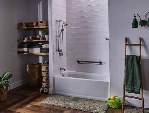 A bathing alcove with a traditional white acrylic tub, white-tile wall surrounds, a showerhead, and a shower wand. 