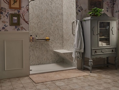 A walk-in shower with a bench seat in an elegant bathroom. 