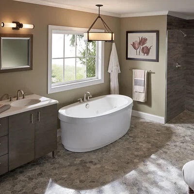 A deep basin standalone tub between a brown vanity and a walk-in shower. 